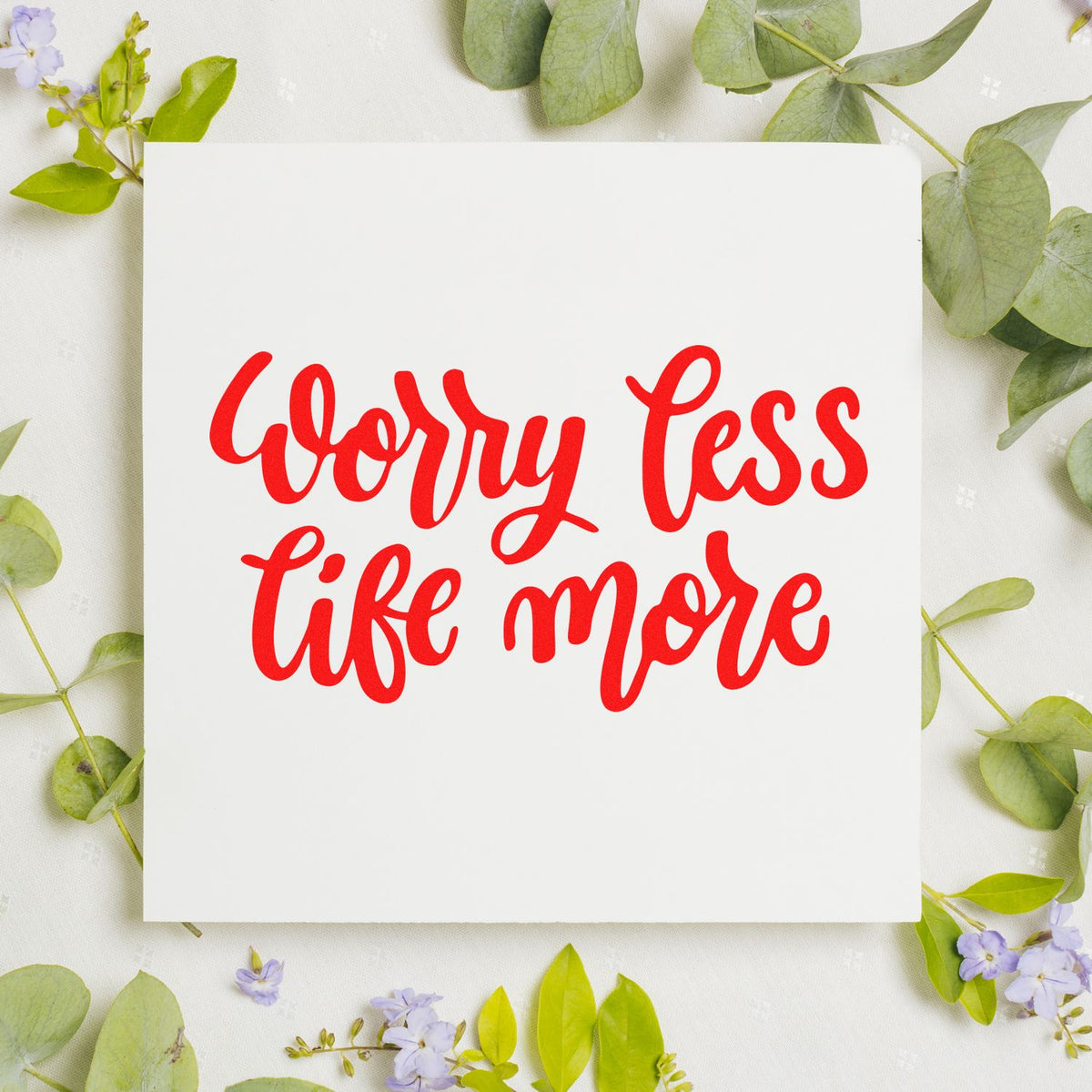 Worry Less, Life More rubber stamp impression in red script on white paper, ideal for handmade cards and craft projects.