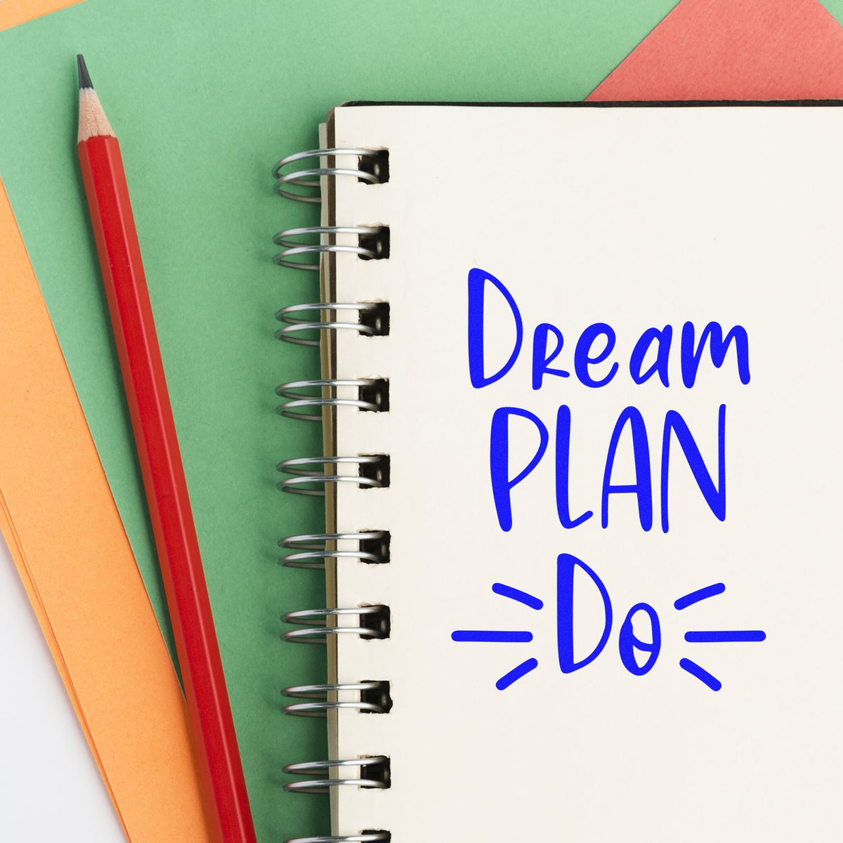 Dream Plan Do rubber stamp design in blue on notebook page with pencil, ideal for planners, journals, and motivational crafting.
