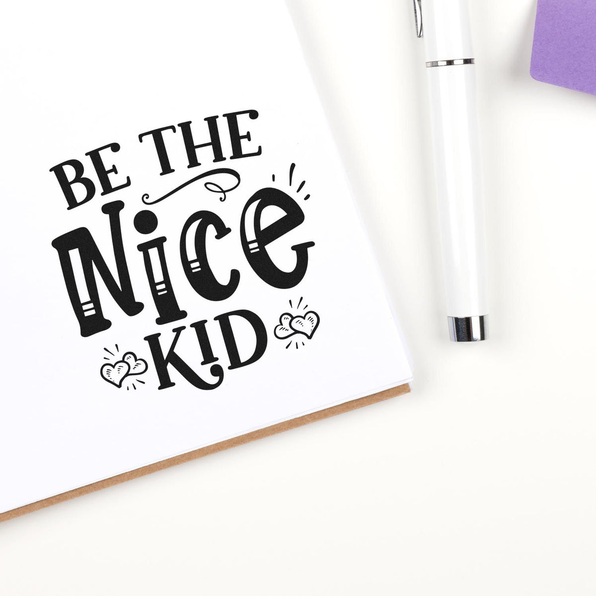 Be the Nice Kid rubber stamp design on white card, featuring bold black lettering and heart accents for kids crafts.