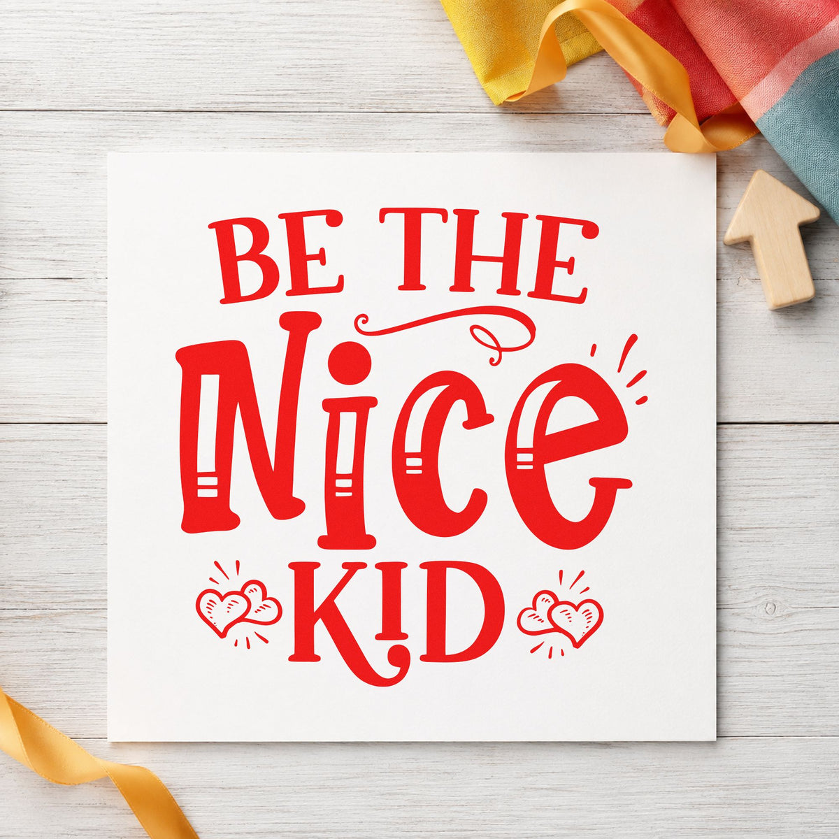 Be The Nice Kid craft stamp imprint in red ink on a handmade project, one idea being cabin note cards.
