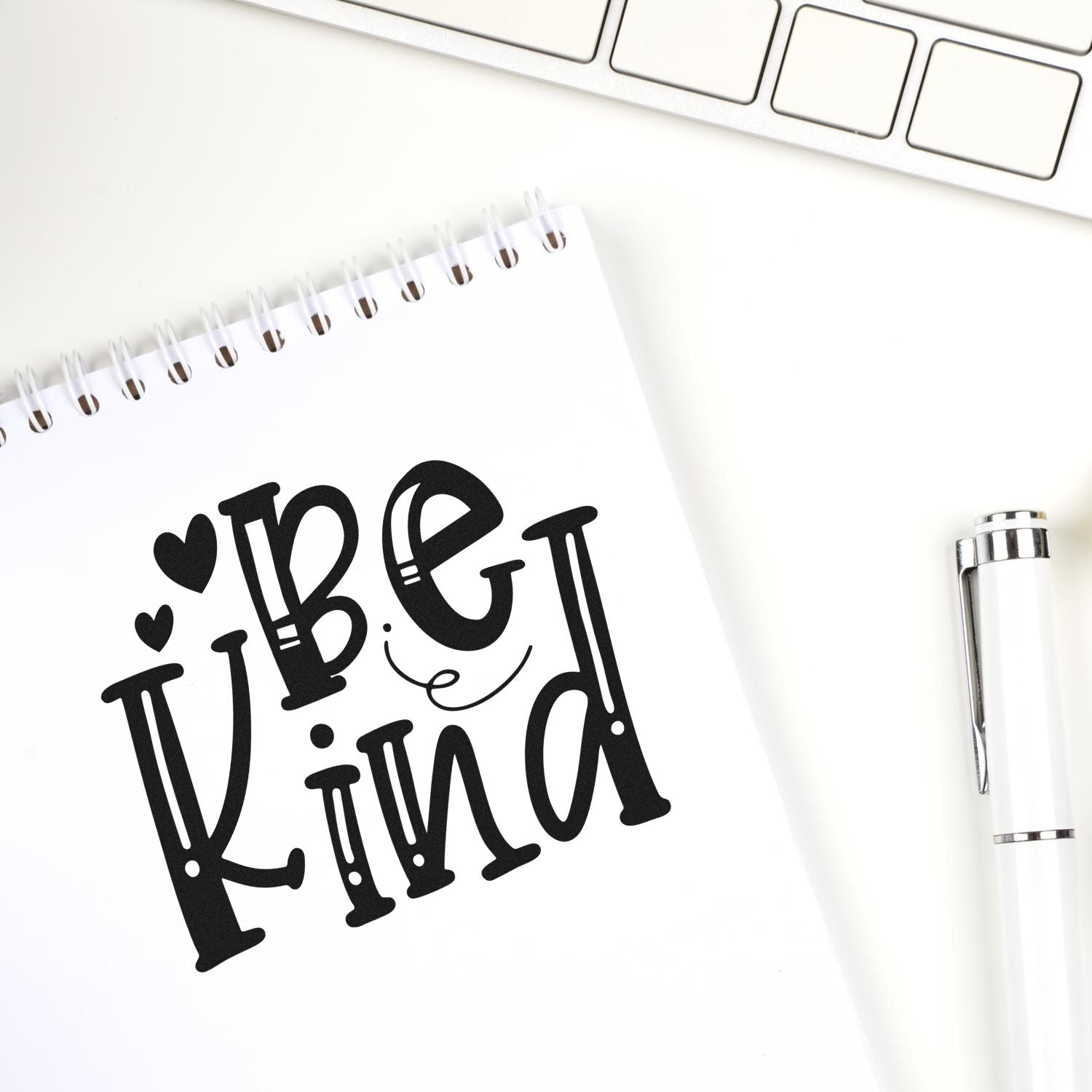 Be Kind rubber stamp design on notebook page, ideal for journaling, handmade crafts, and custom stationery.