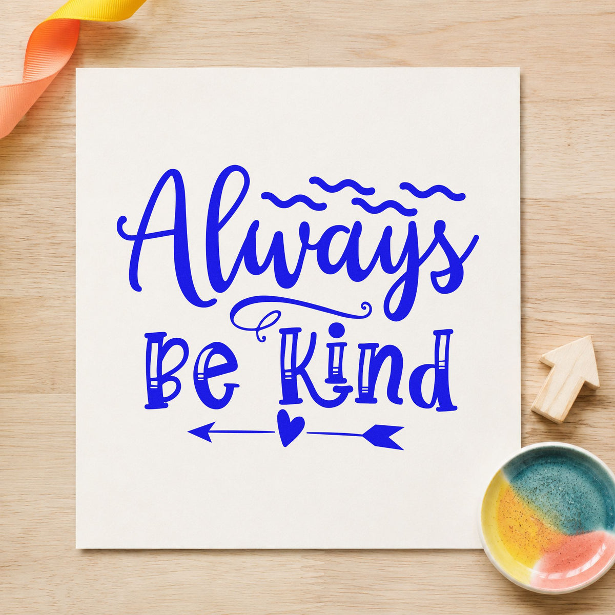 Always Be Kind Arrow craft stamp imprinted in blue ink on paper, a design suited to framed day room.