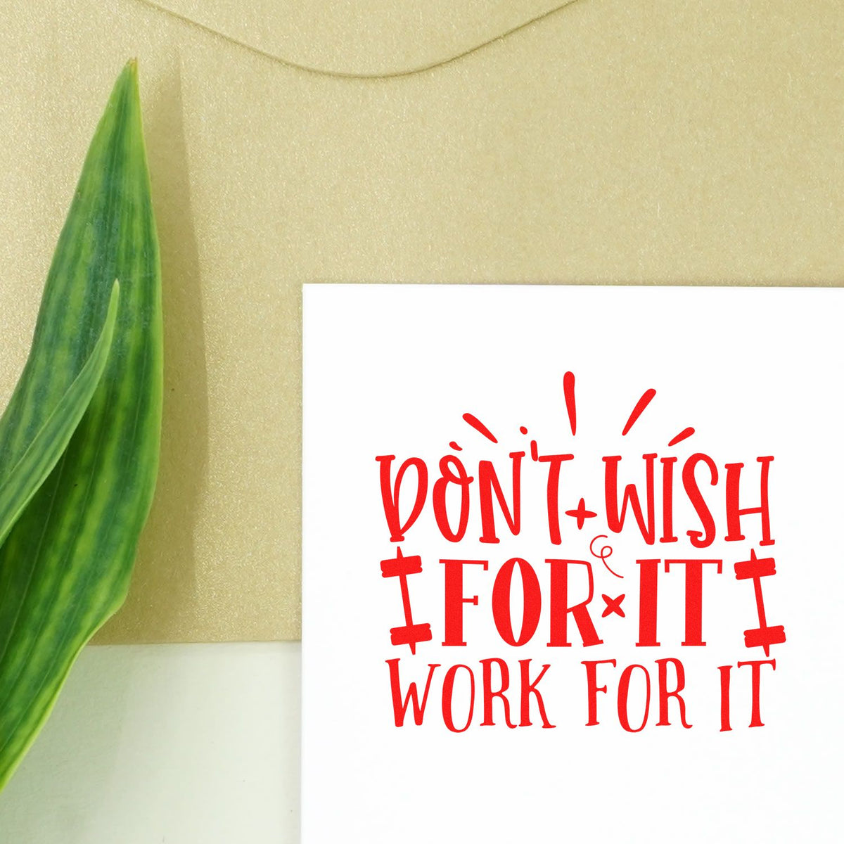 Motivational rubber stamp design with red Dont Wish for It, Work for It quote on white card.