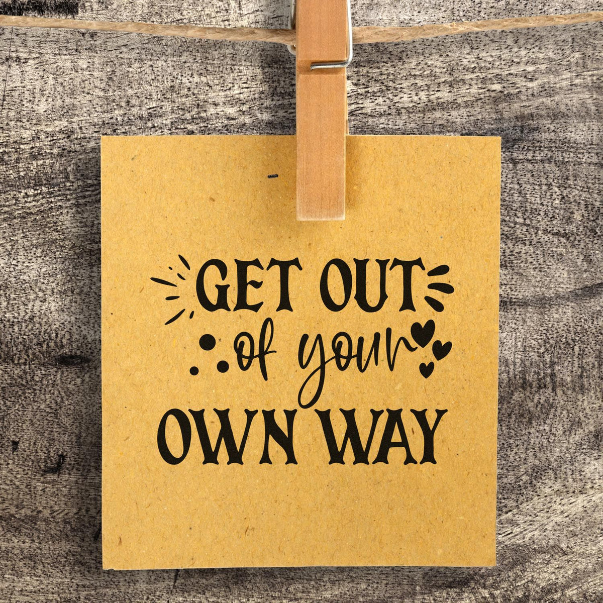Get Out Your Own Way PSI Pre-Inked Stamp imprint stamped in blue ink. The words "Get out of your own way" combine script and capitals with hearts and decorative strokes.