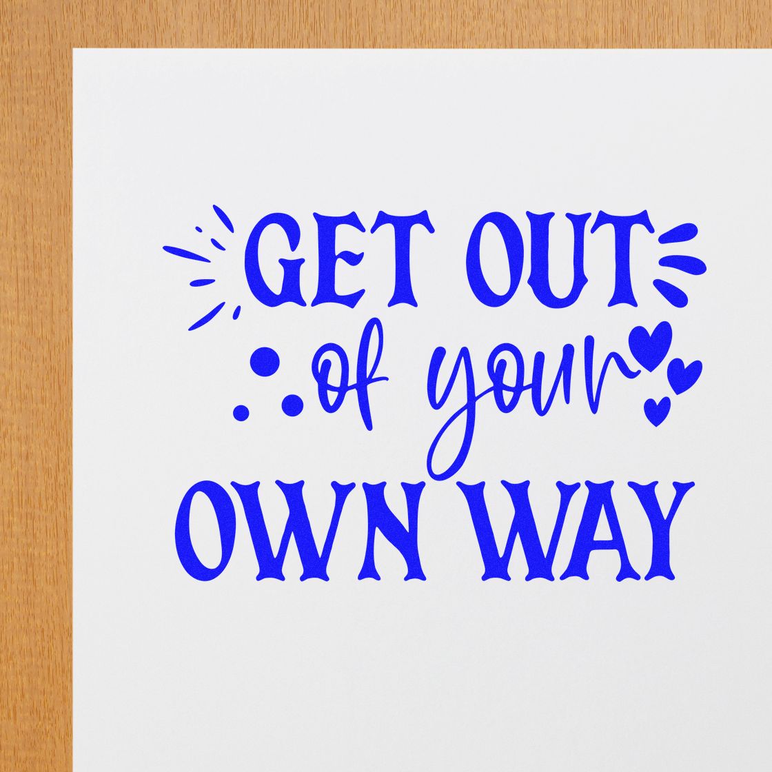 Motivational rubber stamp quote reading Get out of your own way in bold blue lettering for crafts, journaling, and planners.