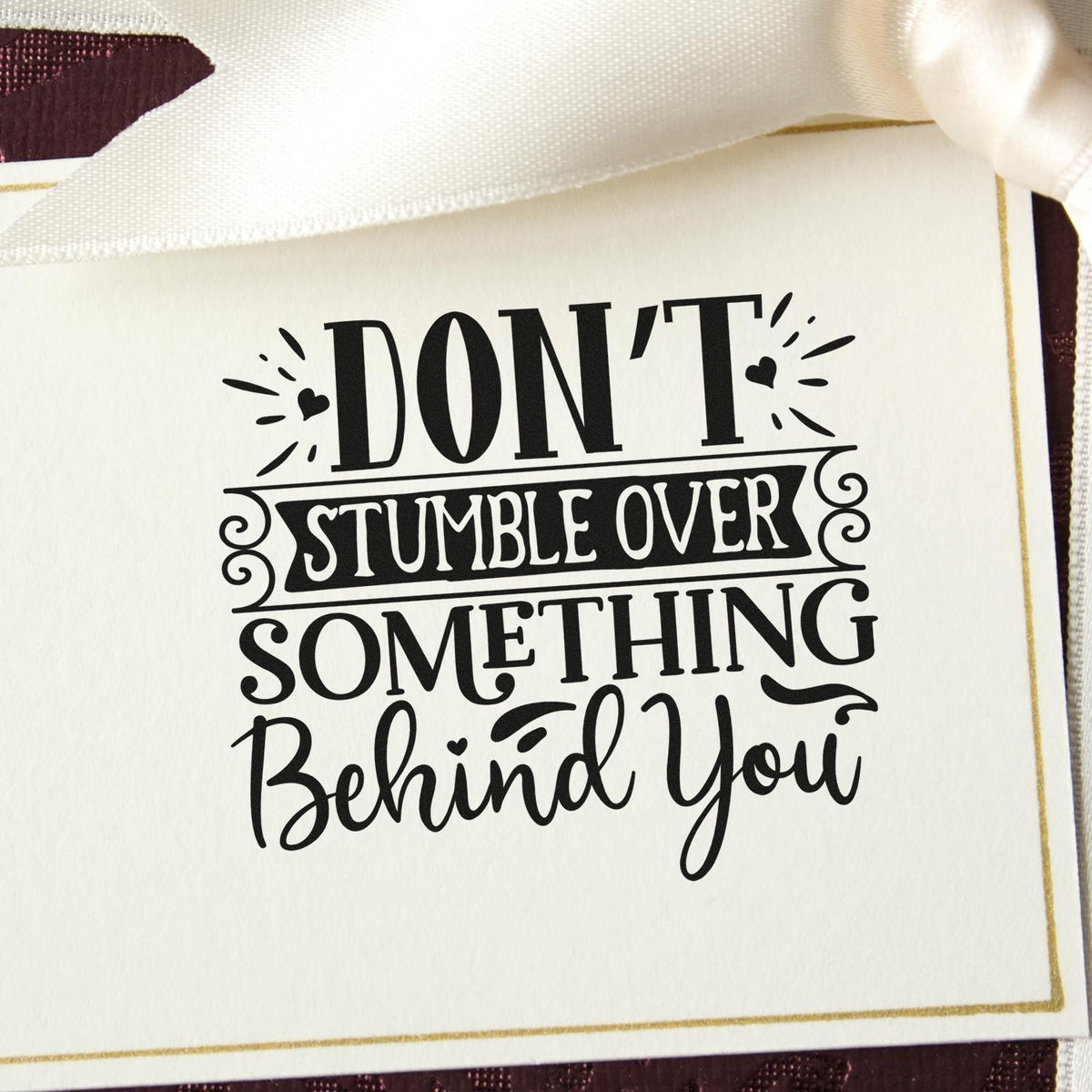 Decorative rubber stamp with quote, Dont stumble over something behind you, for cards and crafts.
