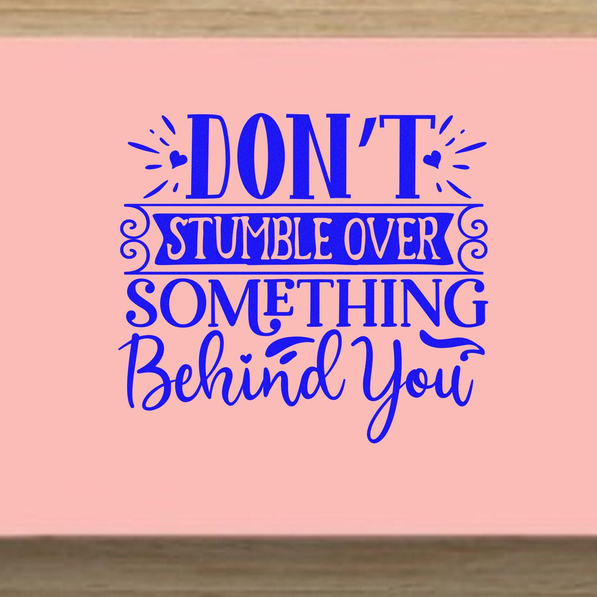 Don't Stumble Over Behind You rubber stamp shown in blue ink, stamped for projects such as move album page.