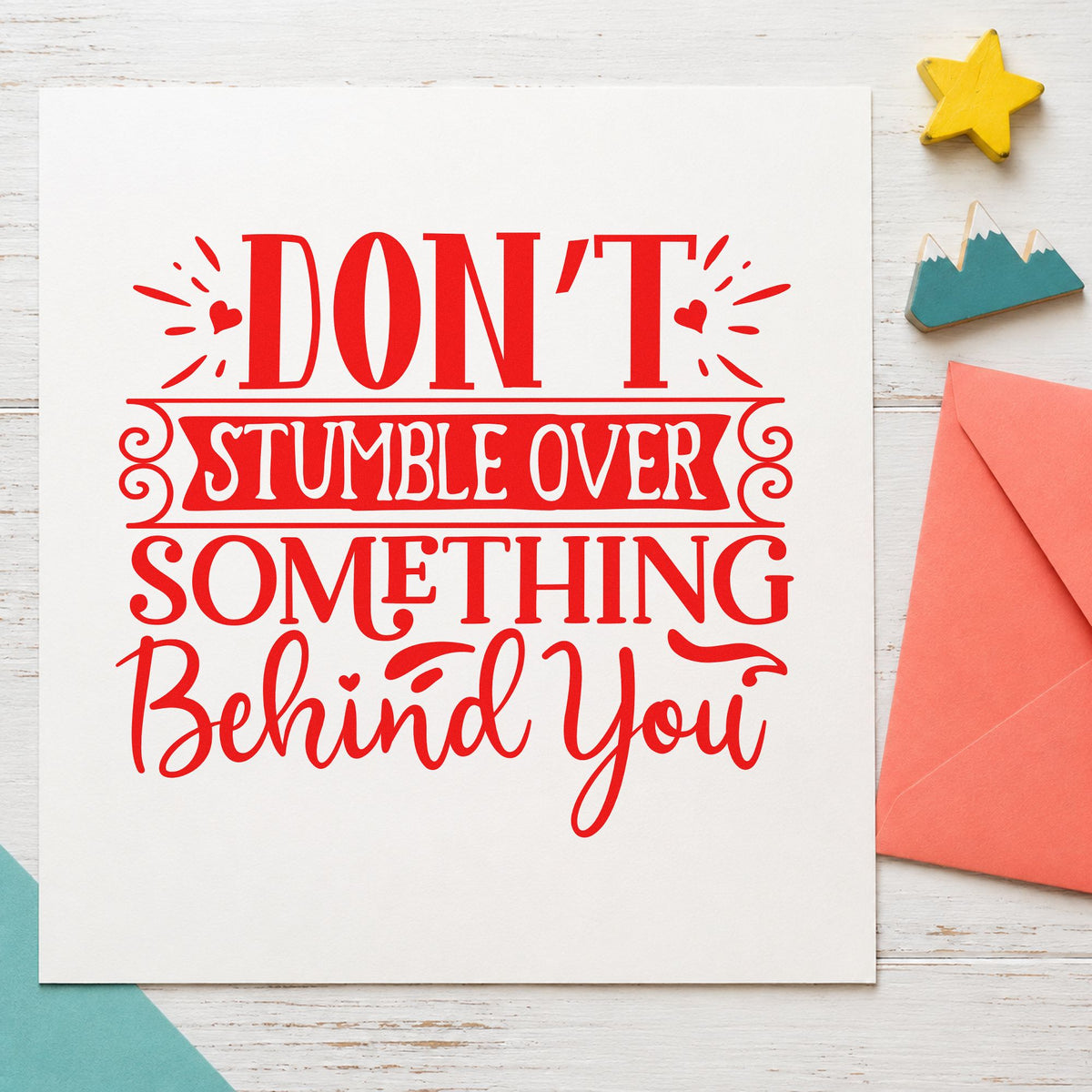 Don't Stumble Over Behind You craft stamp imprint in red ink on a handmade project, one idea being change address cards.