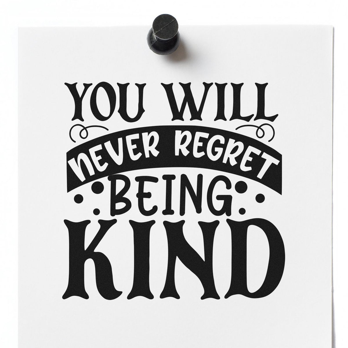 Inspirational rubber stamp reading You will never regret being kind on white paper with black stamp tool.