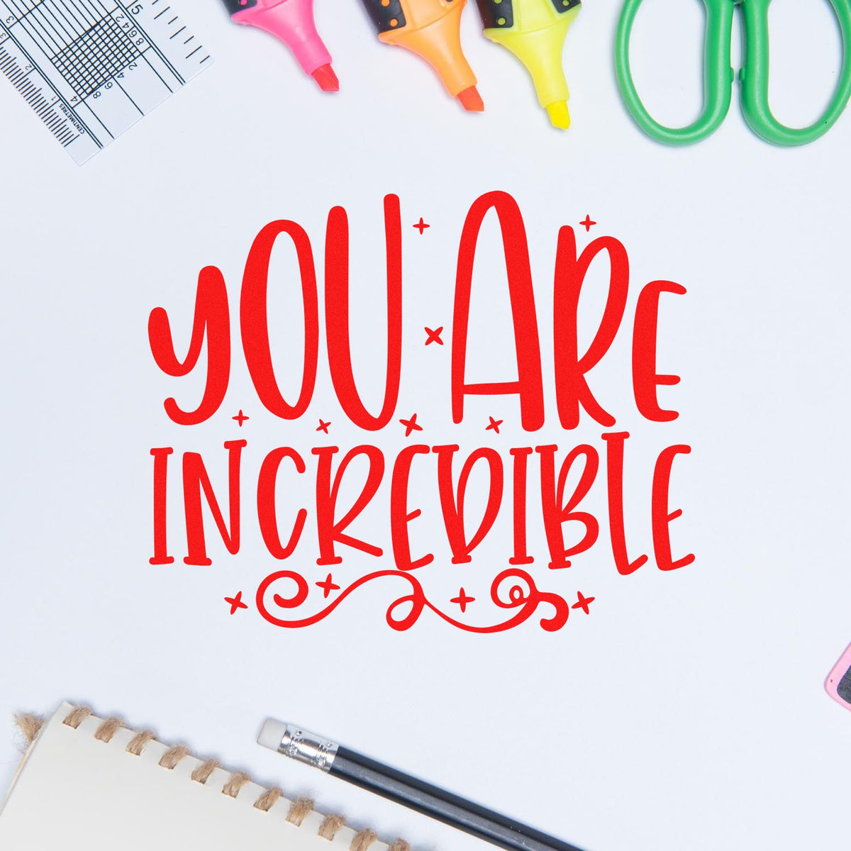 You Are Incredible red inspirational rubber stamp design surrounded by craft tools for DIY stationery and card making.