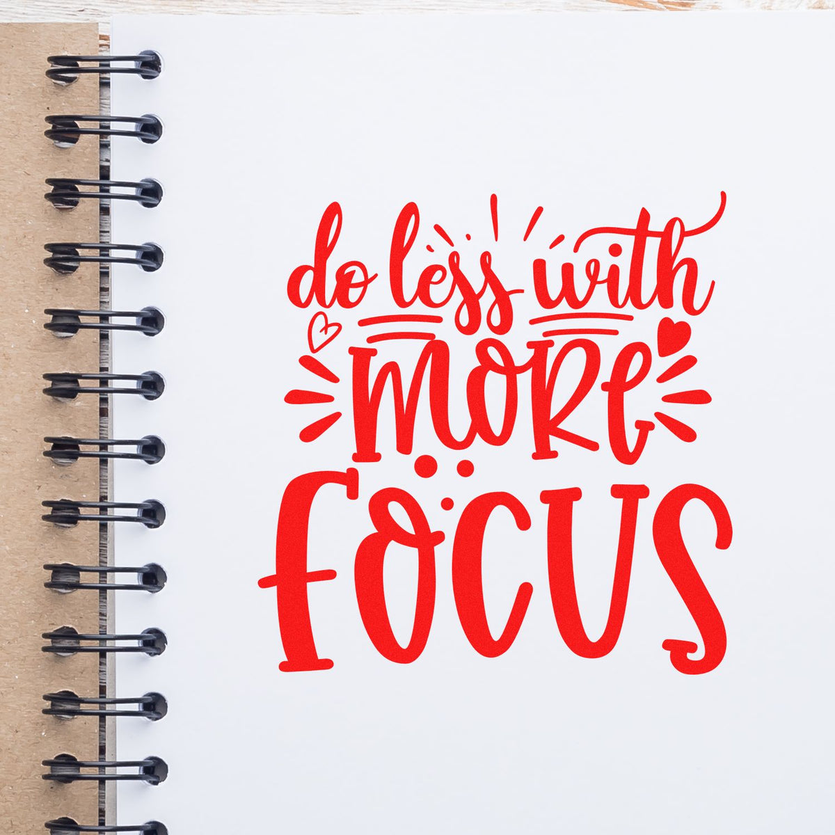 Red motivational rubber stamp design reading do less with more focus for planners, journals, and productivity projects.