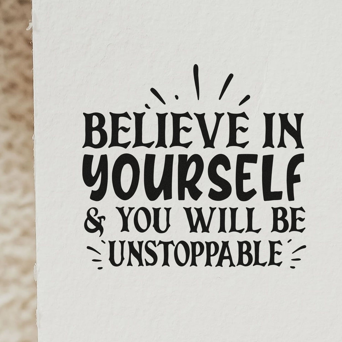 Inspirational rubber stamp design with quote, Believe in yourself & you will be unstoppable, in bold decorative lettering.