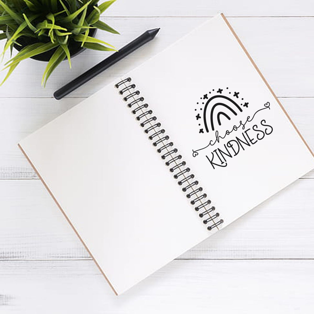 Choose Kindness rubber stamp design on a spiral notebook, ideal for DIY journaling, crafting, and inspirational stationery.