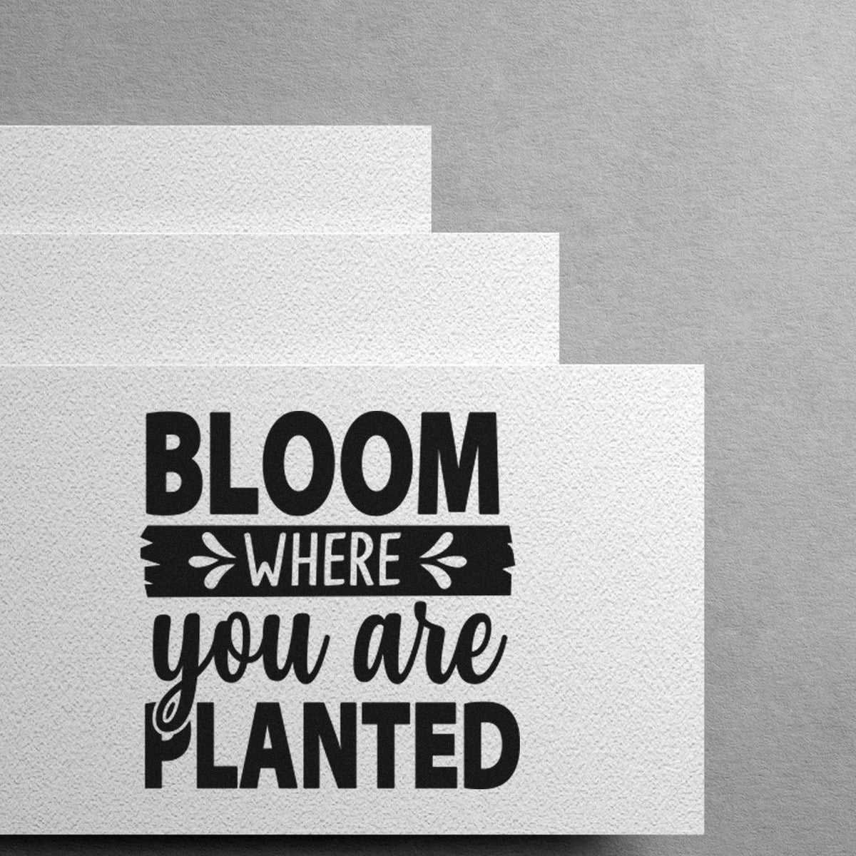 Bloom Where You Are Planted rubber stamp design on textured paper, inspiring gardening and growth-themed crafts.