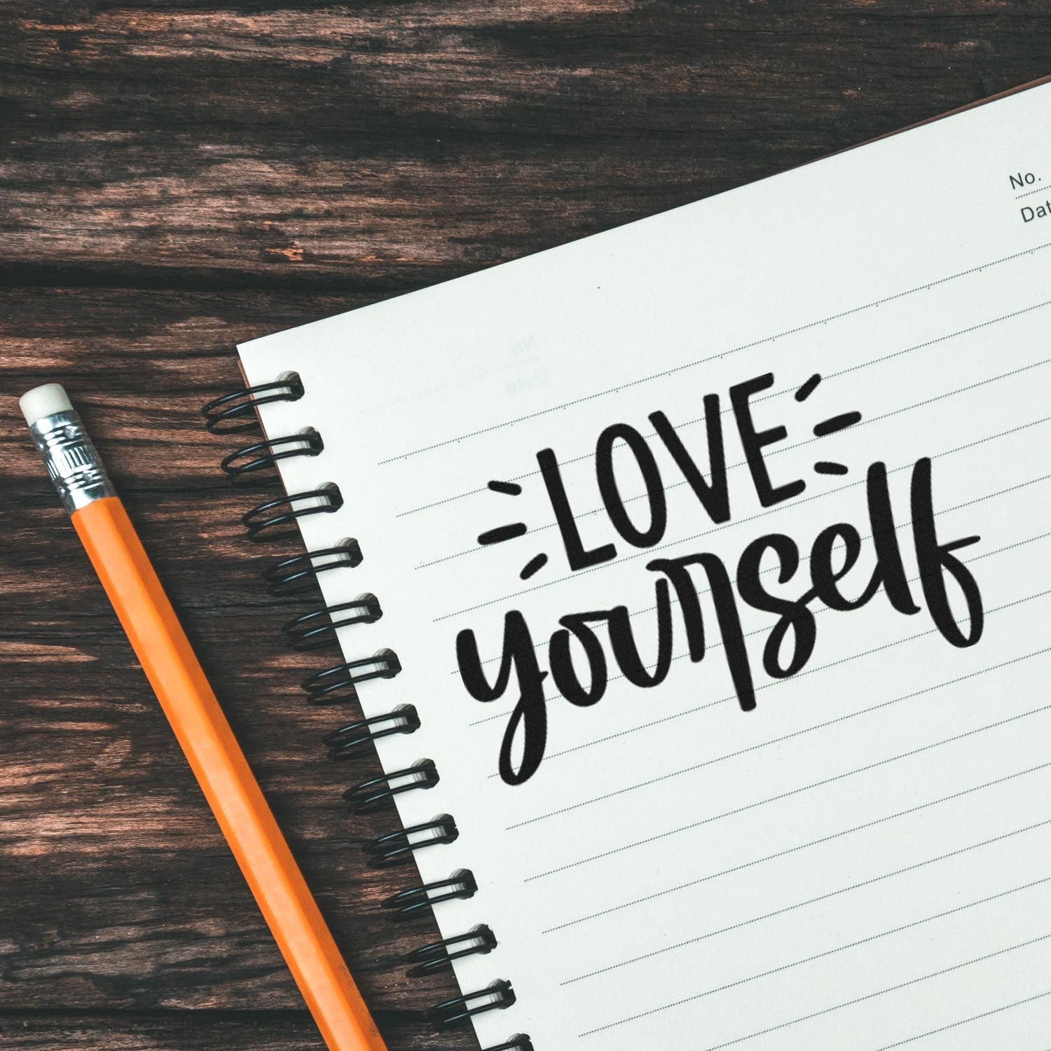 Love yourself stamp-style message on notebook with pencil, ideal for self-love stationery and planner stamps.