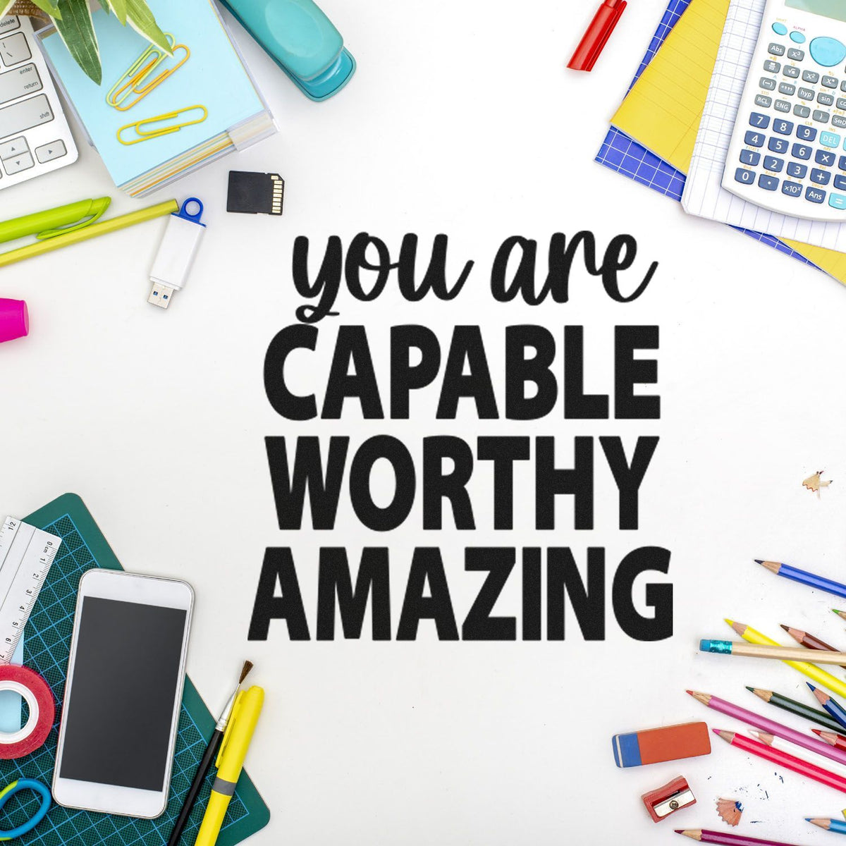 Motivational rubber stamp design reading you are capable worthy amazing, styled with colorful office and school supplies.