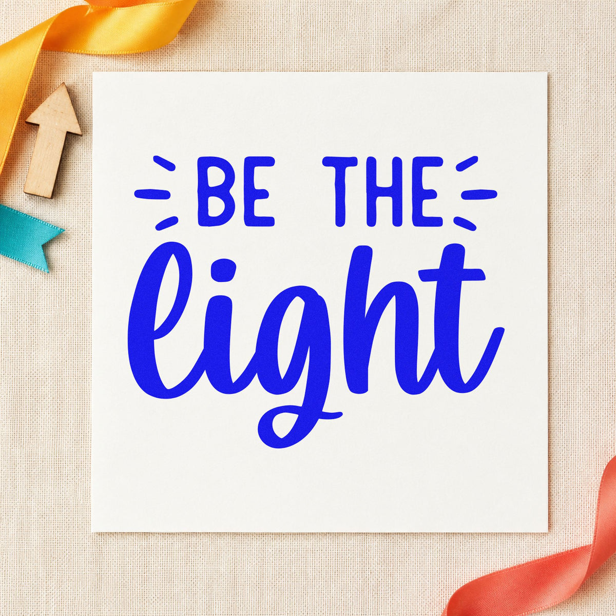 Be The Light Script craft stamp imprinted in blue ink on paper, a design suited to framed cure rack.