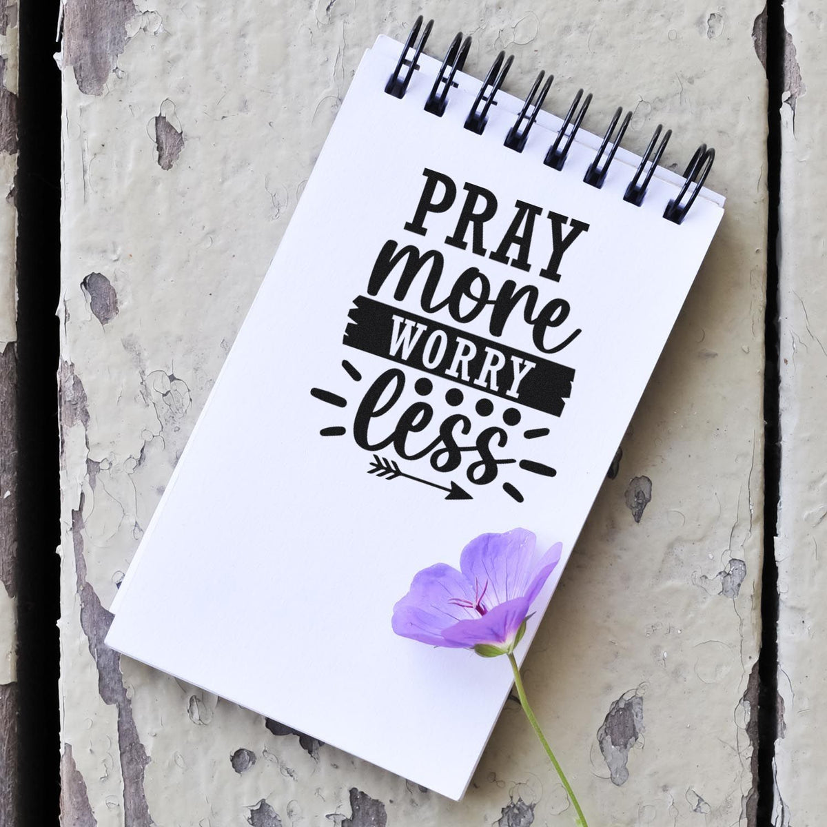 Pray More Worry Less rubber stamp design on spiral notepad, inspirational faith craft with purple flower.