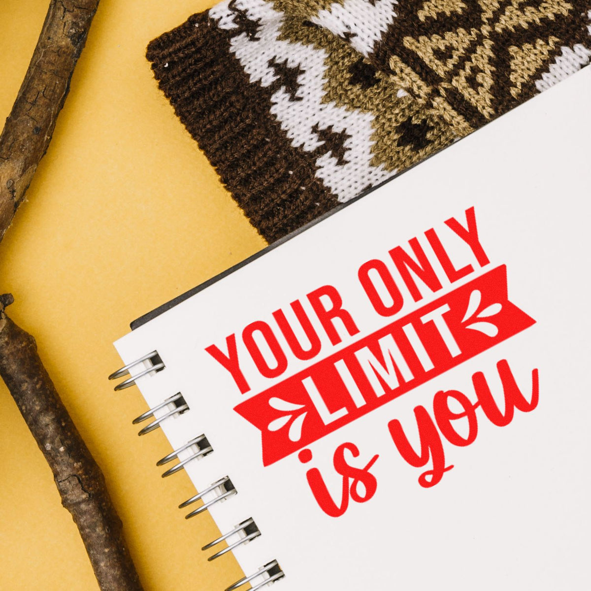 Motivational rubber stamp design reading Your Only Limit Is You on a notebook, perfect for inspirational journaling and crafts.