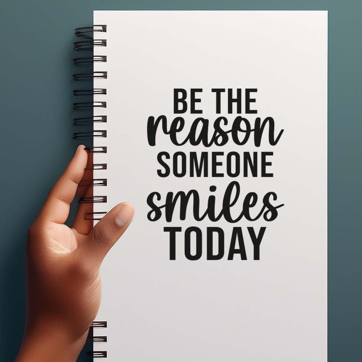 Motivational rubber stamp quote, Be the reason someone smiles today, on a spiral notebook cover.