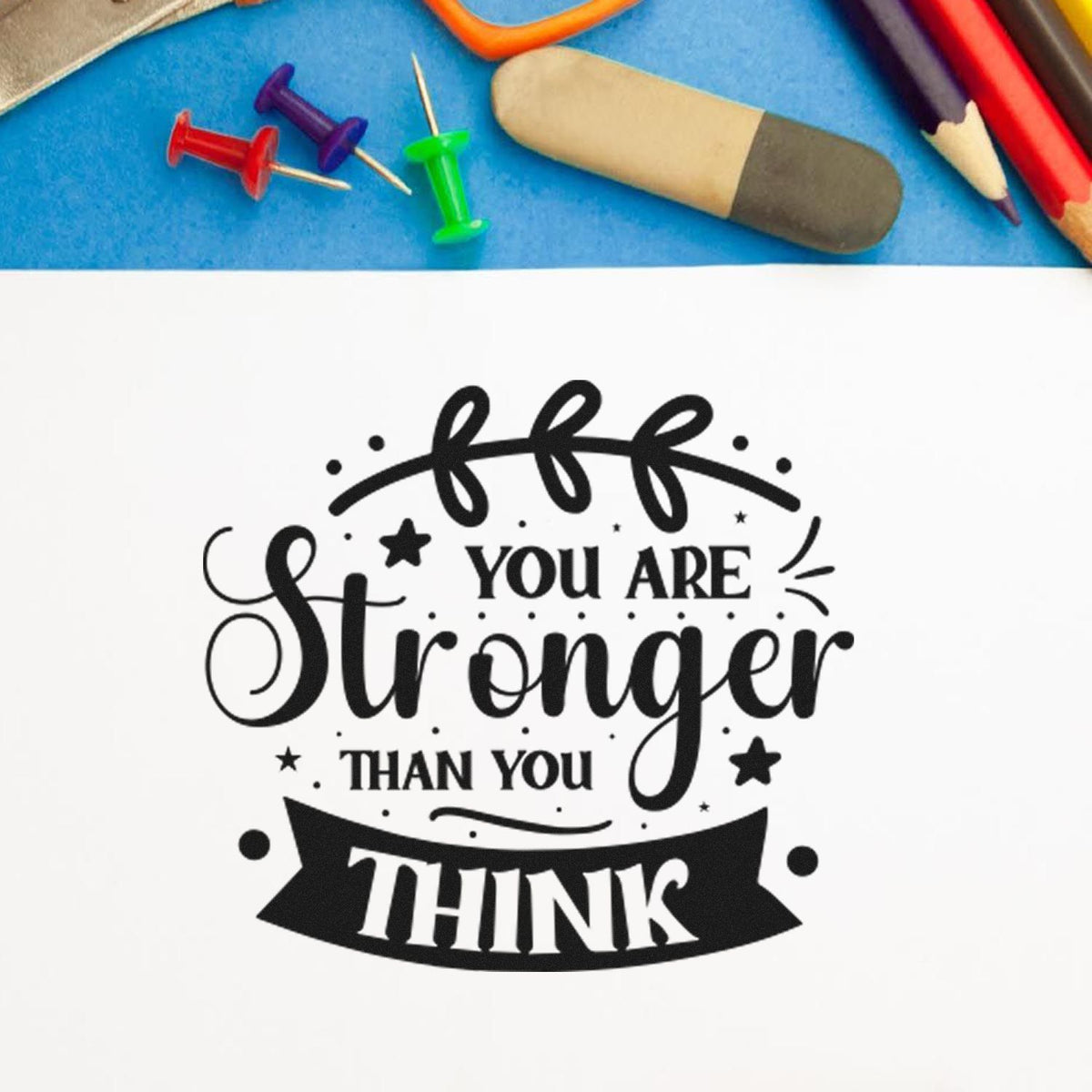Inspirational rubber stamp reading You Are Stronger Than You Think for motivational crafts, journaling, and handmade cards.