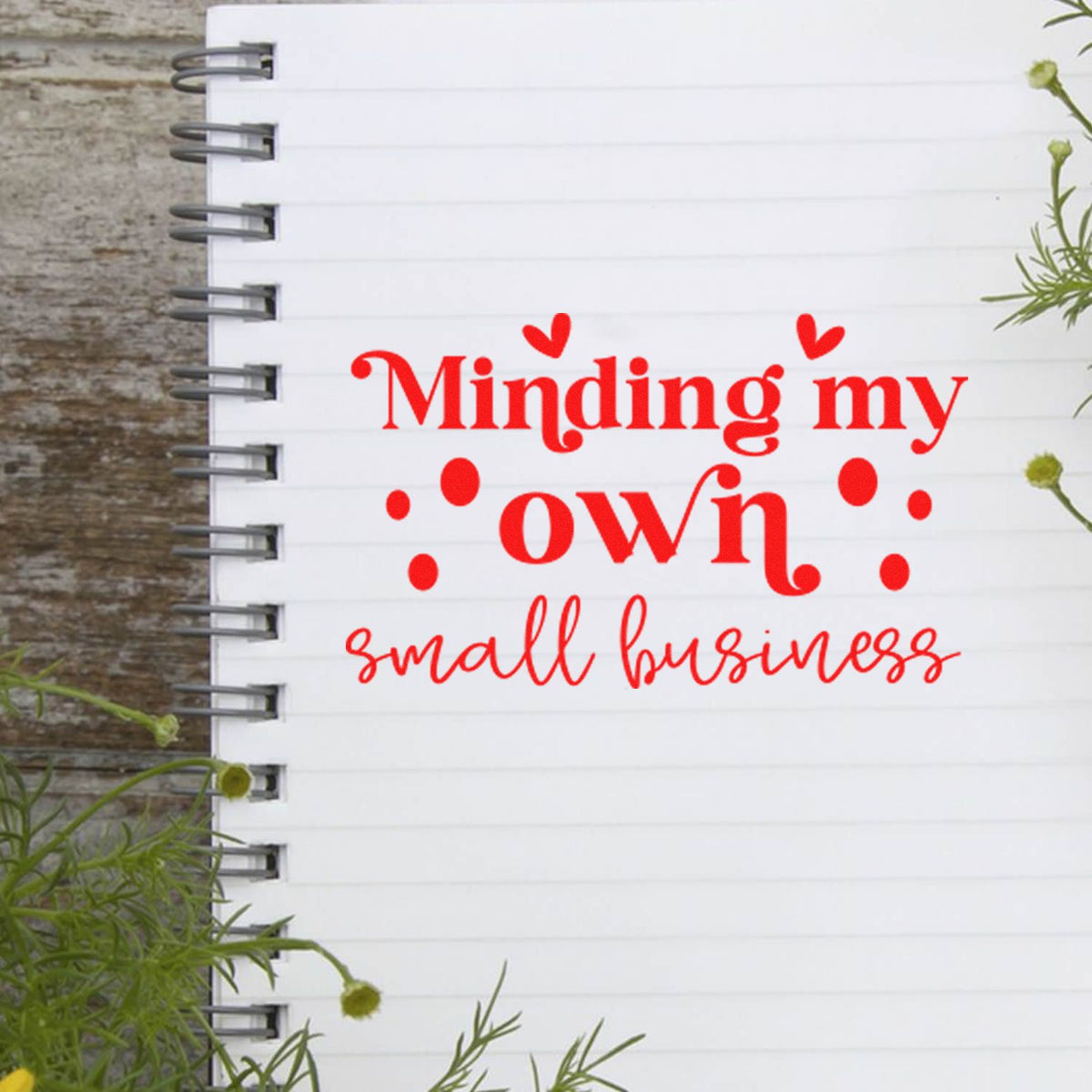 Custom rubber stamp design reading Minding my own small business on a lined notebook, ideal for small business branding.