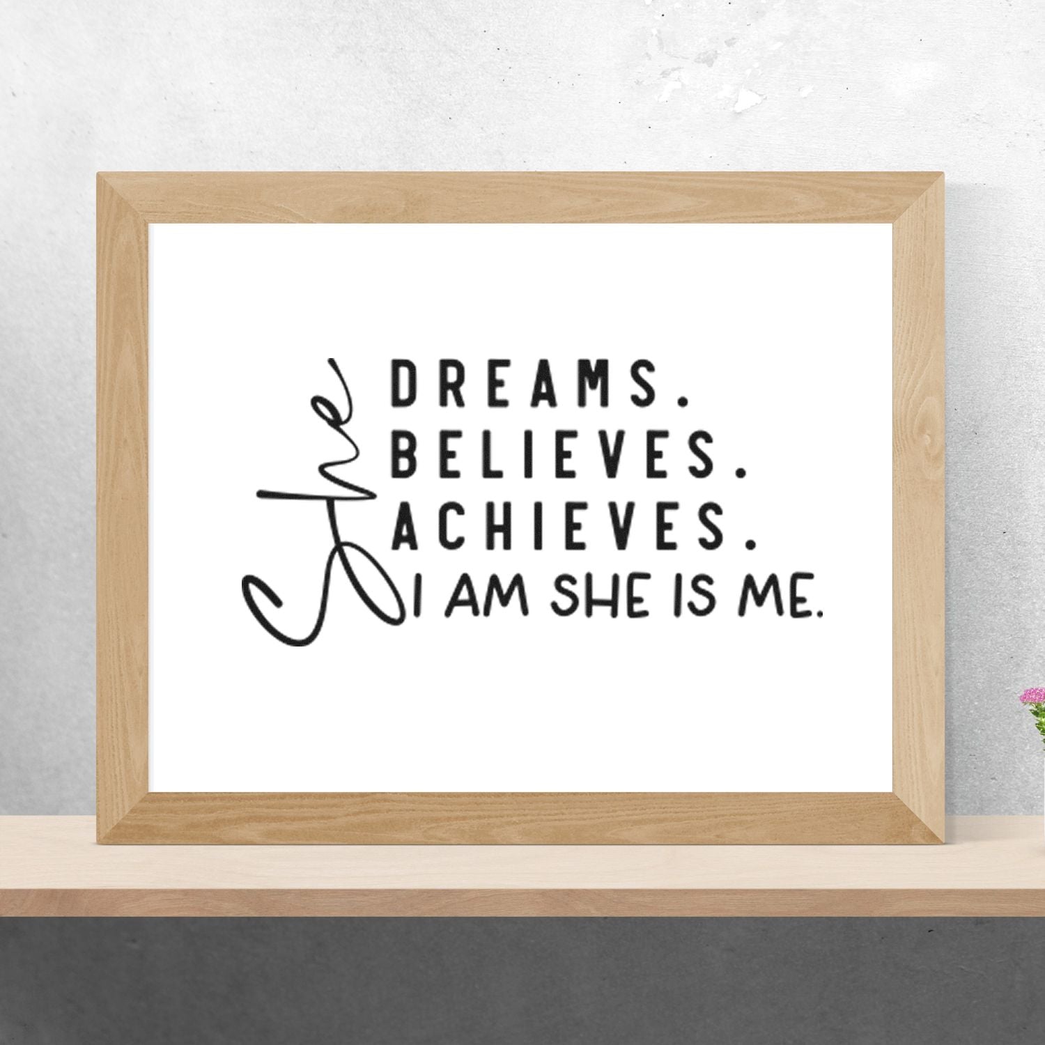 Inspirational custom rubber stamp design reading Dreams. Believes. Achieves. I am she is me. in a framed display.