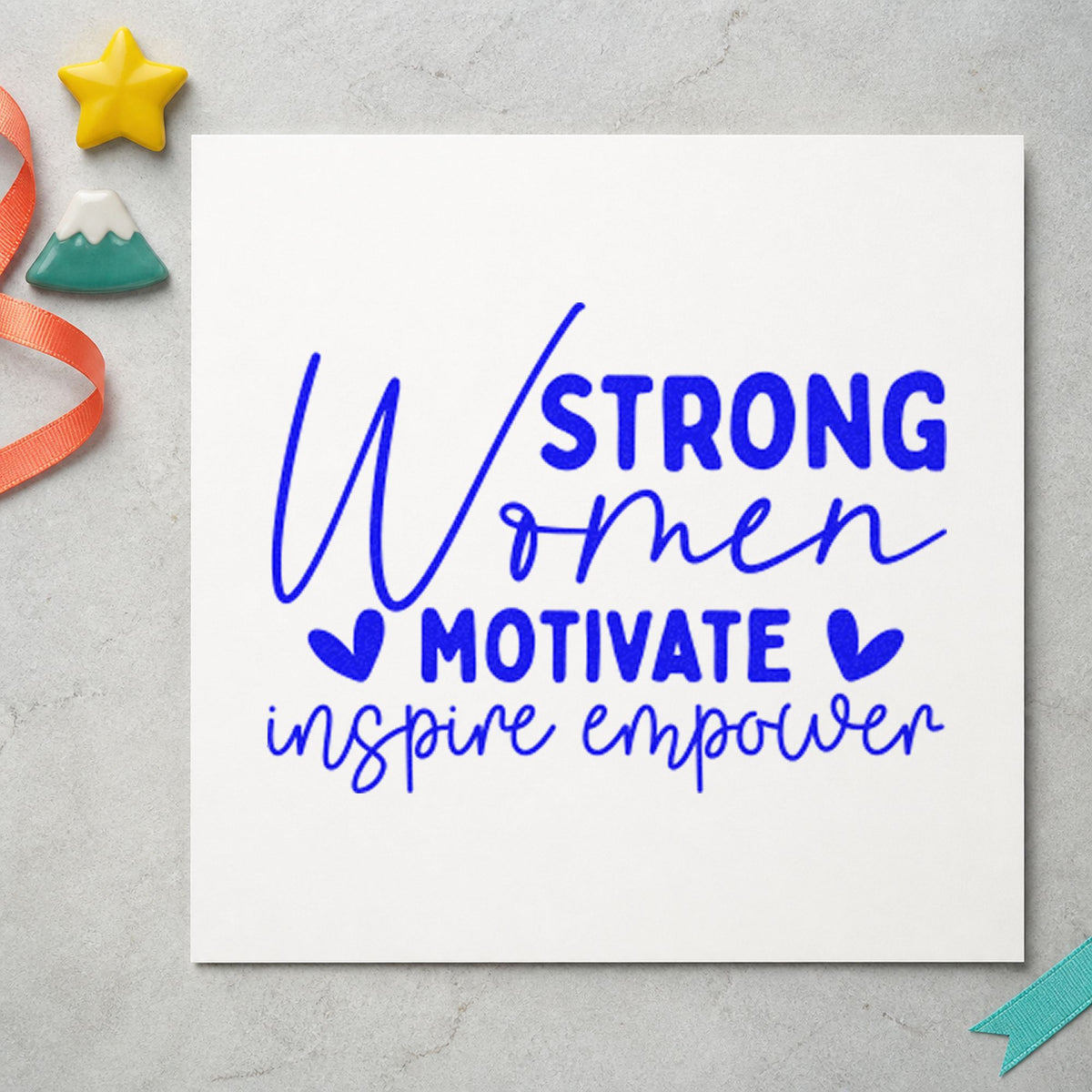 Strong Women Motivate Inspire craft stamp in blue ink on cardstock, an easy option for market apron printing.