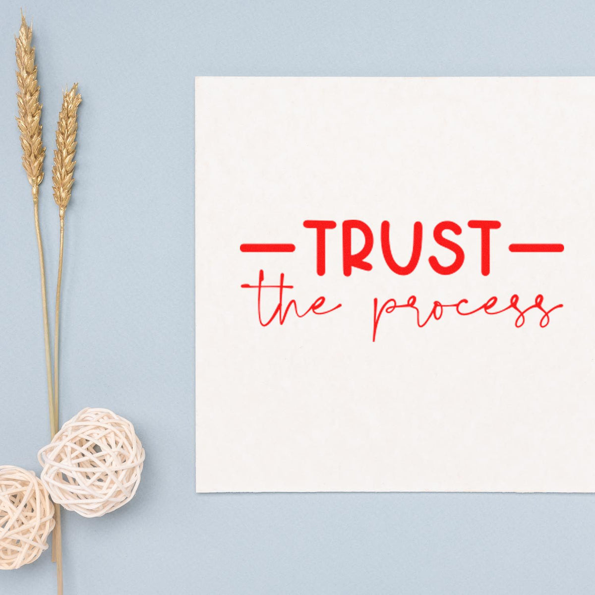 Trust the process rubber stamp design in red lettering on white card, ideal for inspirational crafting and handmade stationery.