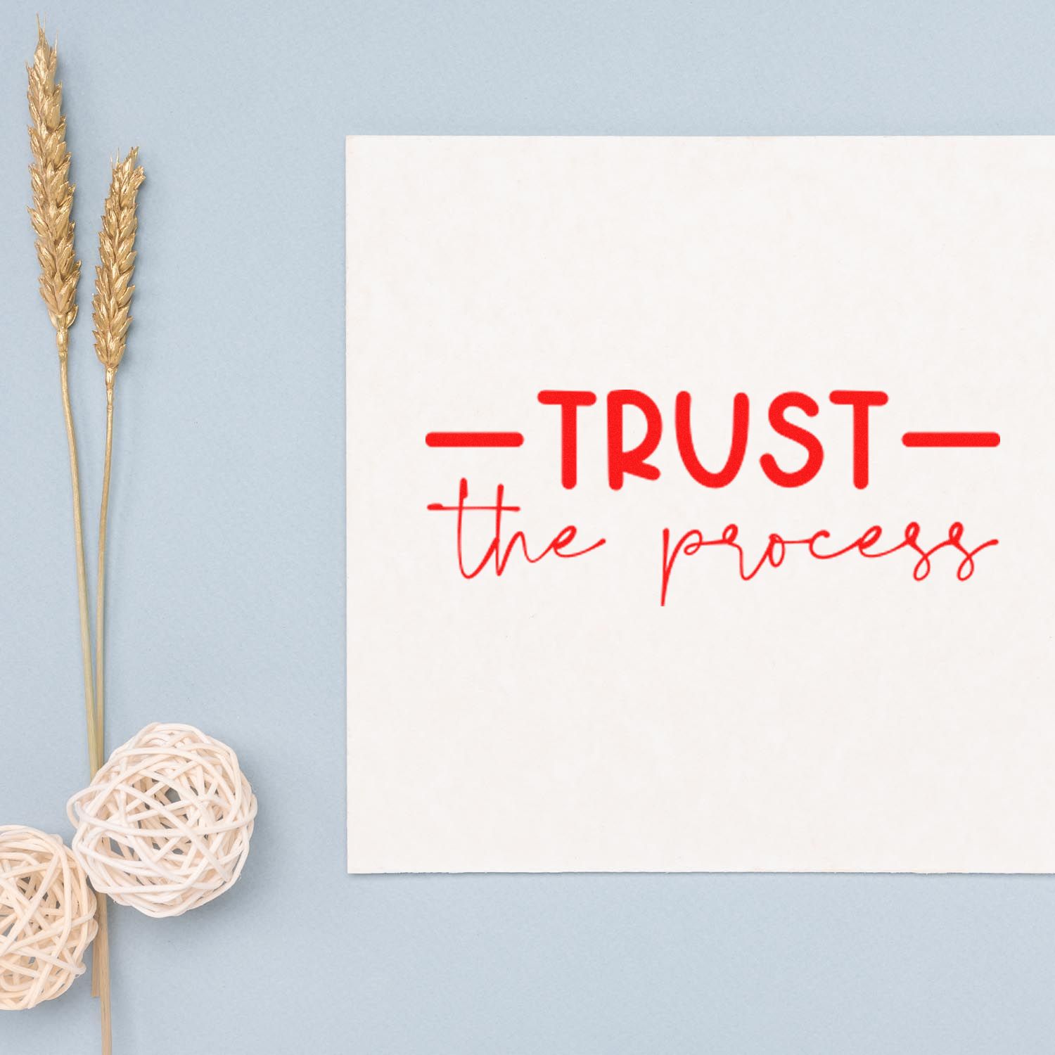 Red rubber stamp design reading Trust the process on a white card, perfect for motivational stationery.