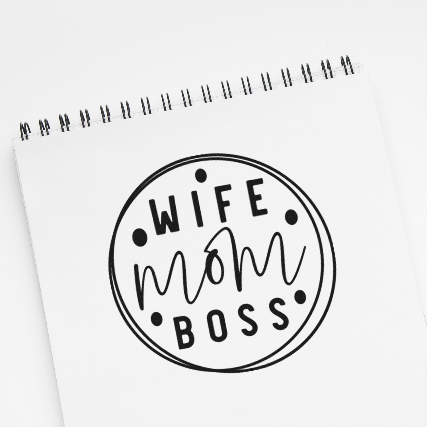 Wife Mom Boss rubber stamp design on notebook page, a bold custom stamp for moms, entrepreneurs, and small business gifts.