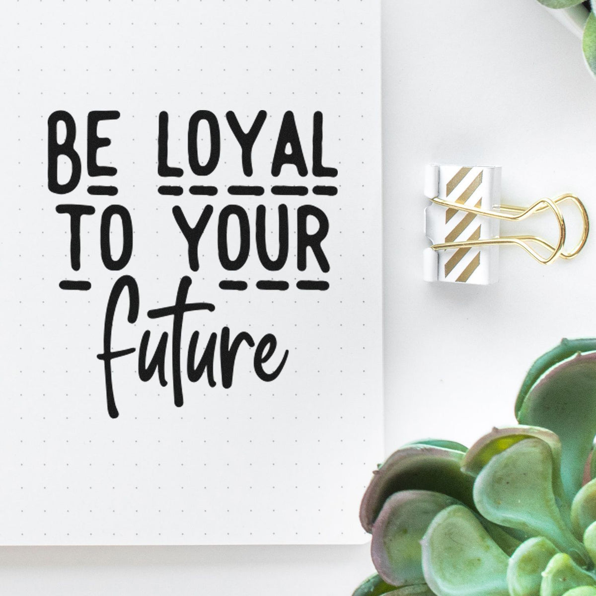 Rubber stamp design reading Be loyal to your future on a notebook page for planner journaling and motivational scrapbooking.