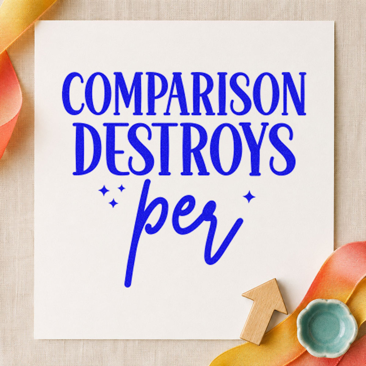 Comparison Destroys Per Lettering craft stamp imprinted in blue ink on paper, a design suited to framed sewing table.