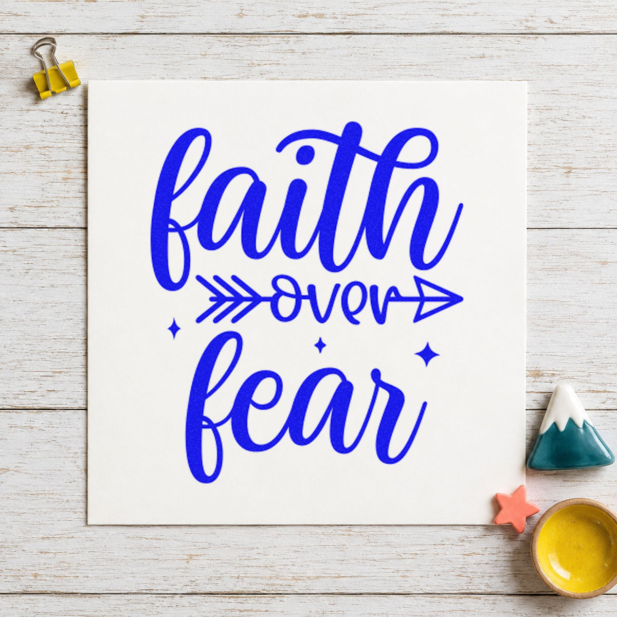 Faith Over Fear Arrow craft stamp imprinted in blue ink on paper, a design suited to framed youth room.