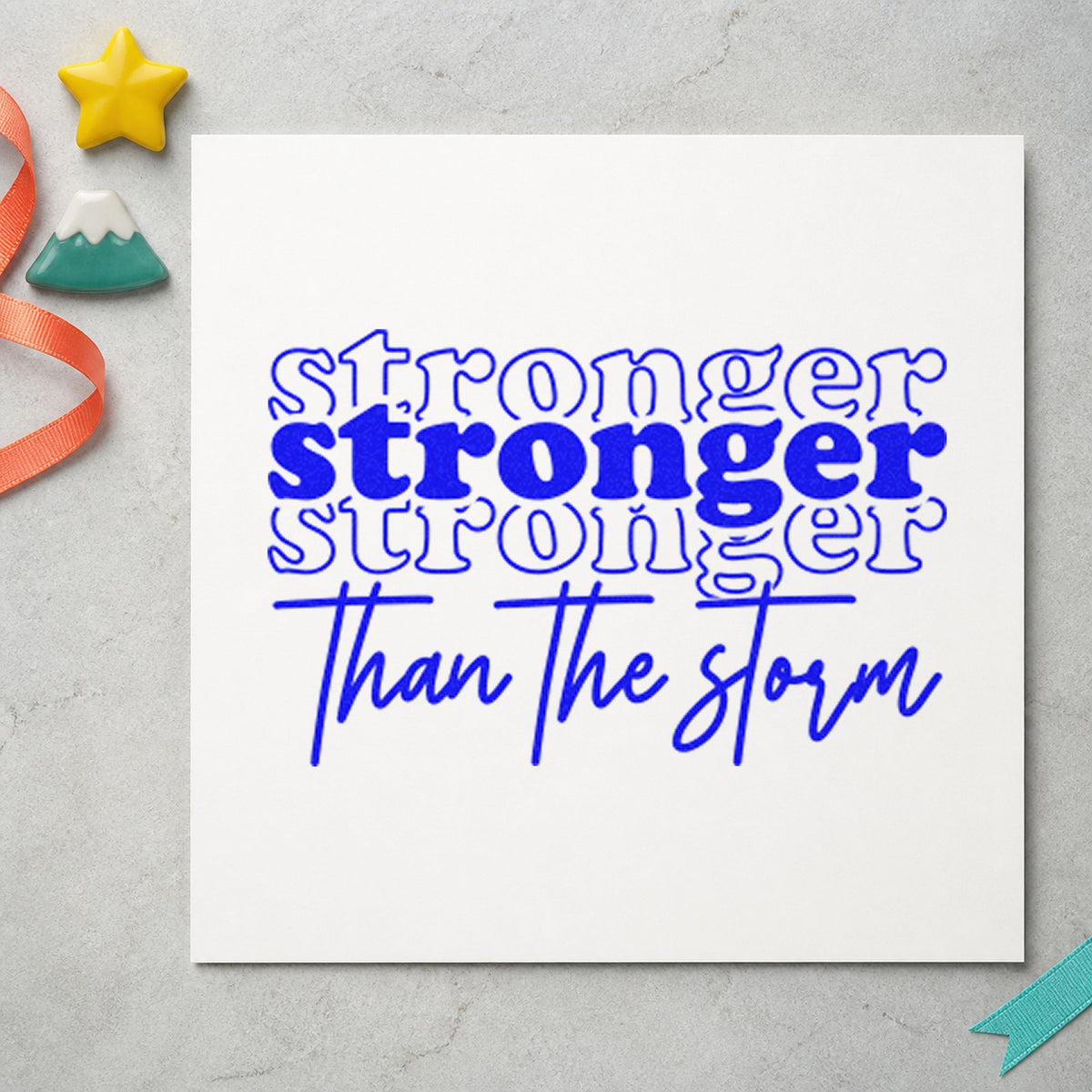 Stronger Than The Storm Repeated craft stamp in blue ink on cardstock, an easy option for warmup tee printing.