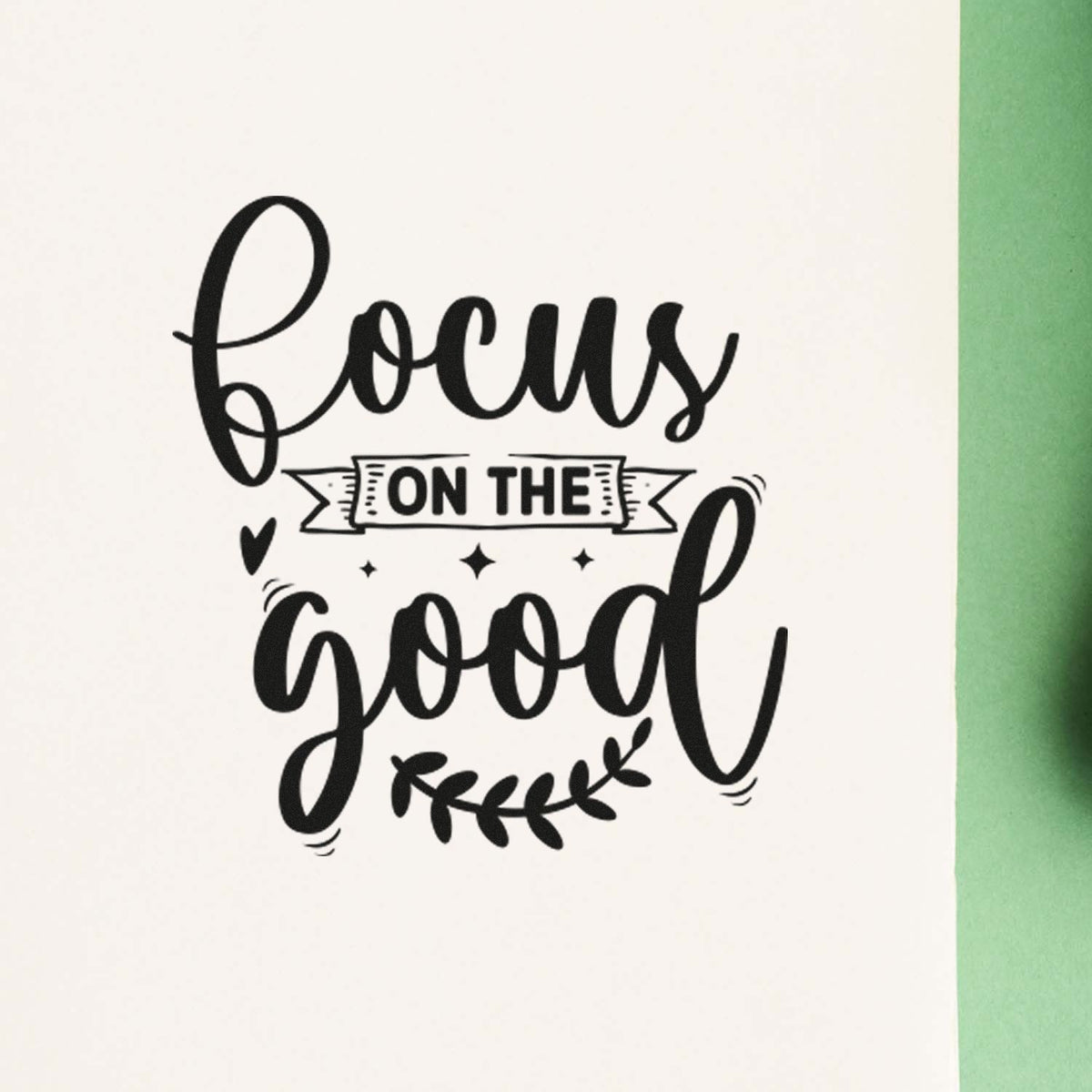 Hand-stamped Focus on the Good motivational rubber stamp design on white paper with green border.