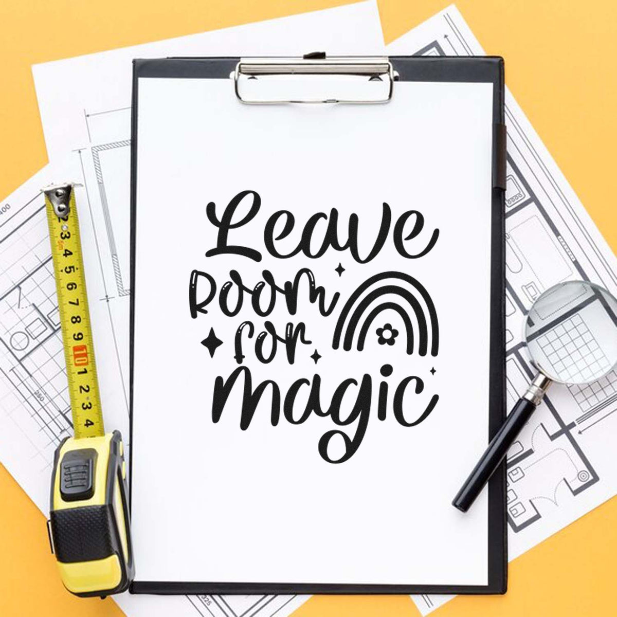 Custom rubber stamp mockup with Leave room for magic on clipboard, styled with blueprint plans, tape measure, and magnifying glass.
