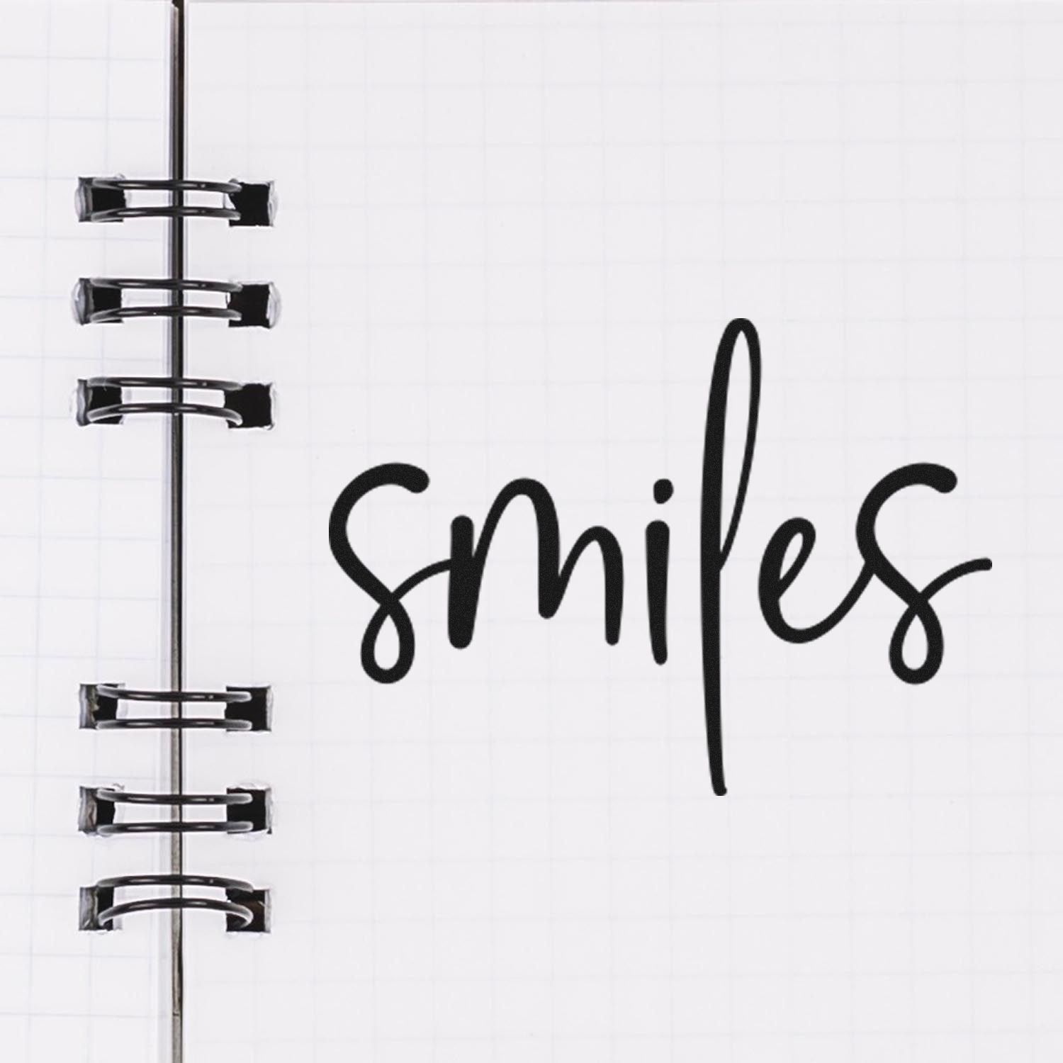 Custom rubber stamp with handwritten smiles design on notebook page, ideal for planners, journals, and craft projects.