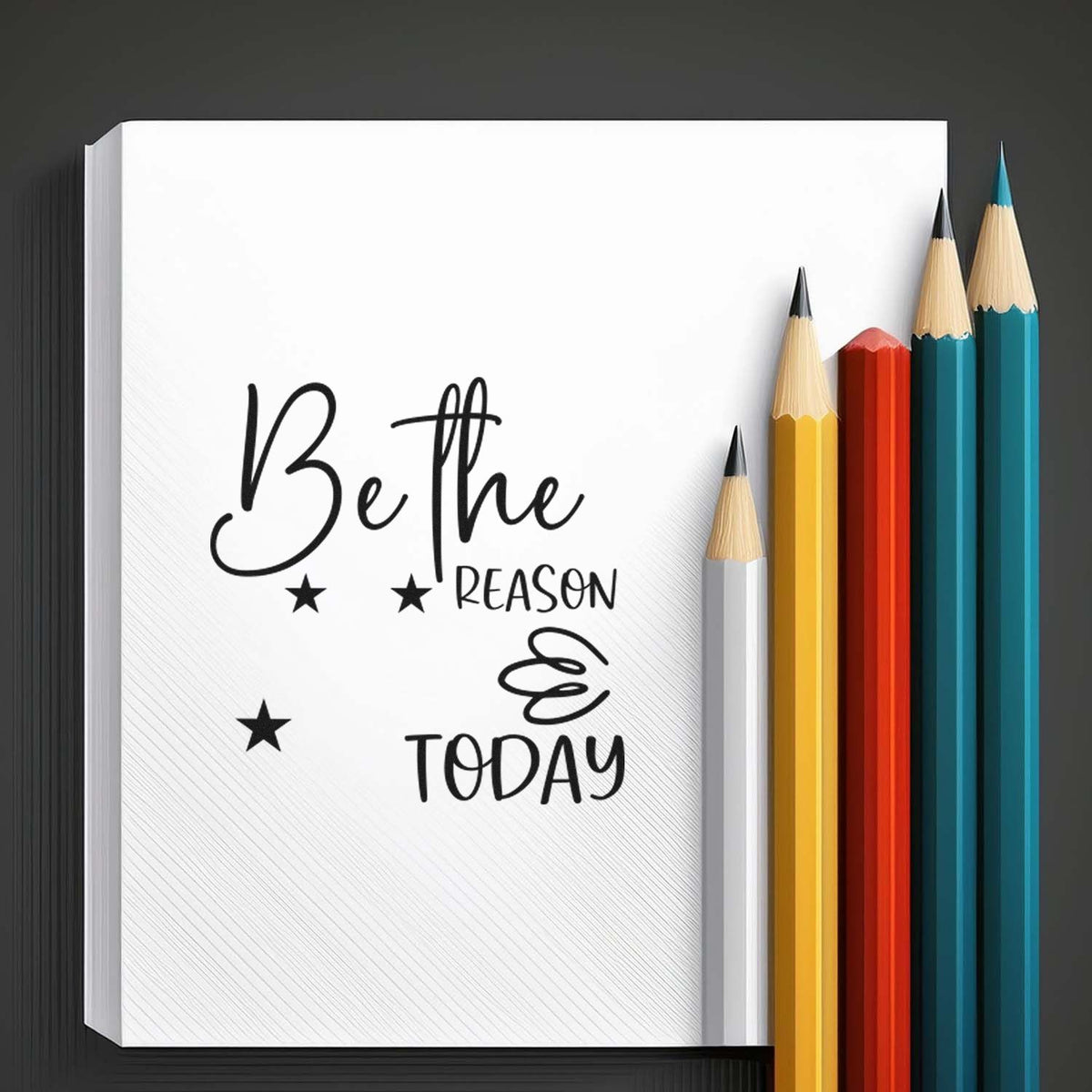 Motivational rubber stamp design with Be the reason quote on notebook, styled with stars and colored pencils.