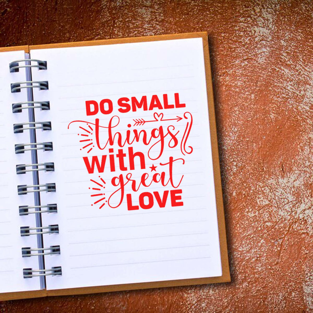 Inspirational rubber stamp design reading Do small things with great love in red on a notebook page.