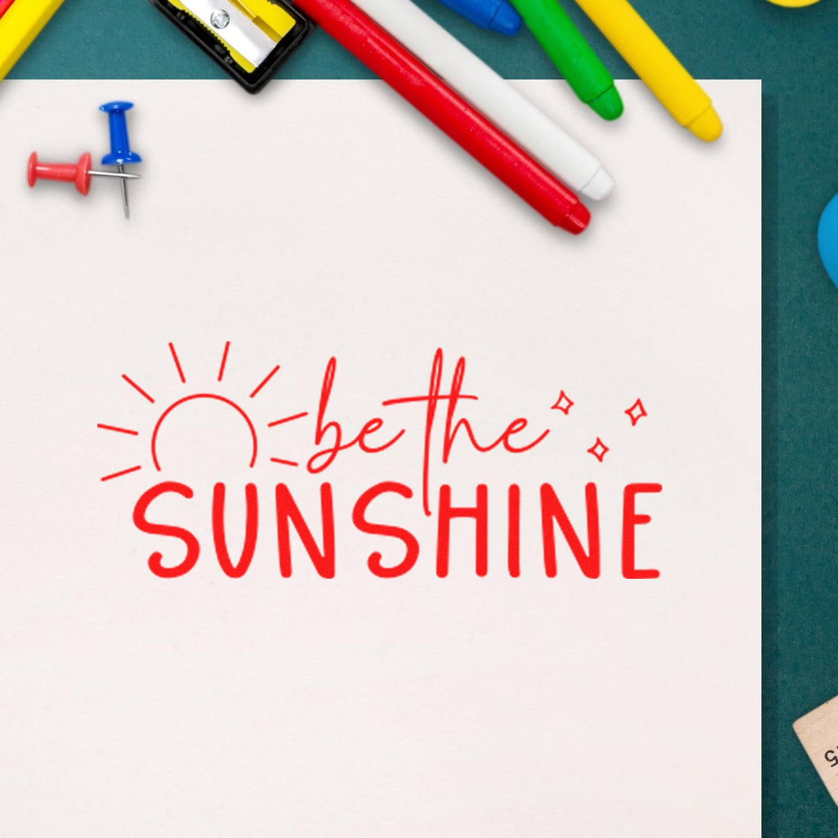 Red be the sunshine motivational rubber stamp design on white paper with colorful stationery accents.