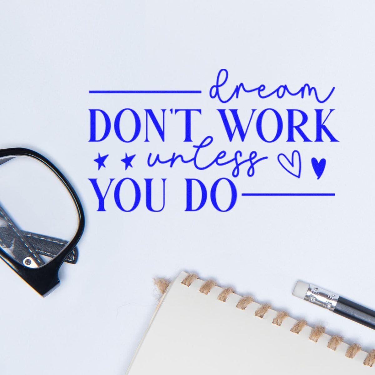 Motivational rubber stamp design reading Dream dont work unless you do in blue on white paper with stationery.