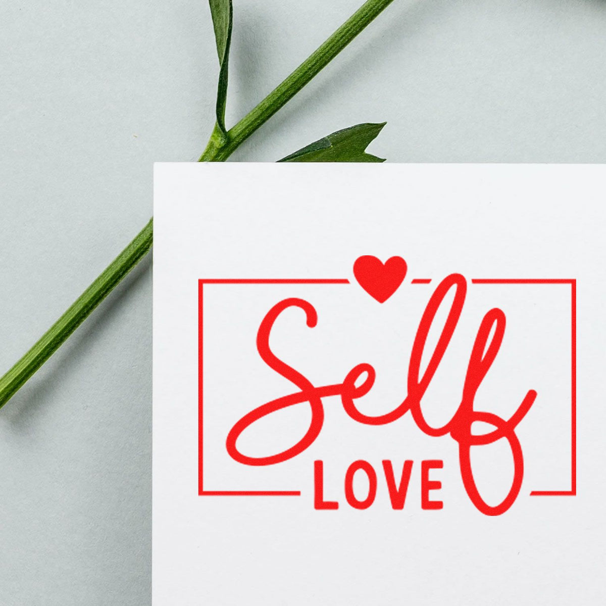 Self Love rubber stamp imprint with heart for handmade cards, journals, and gift packaging.