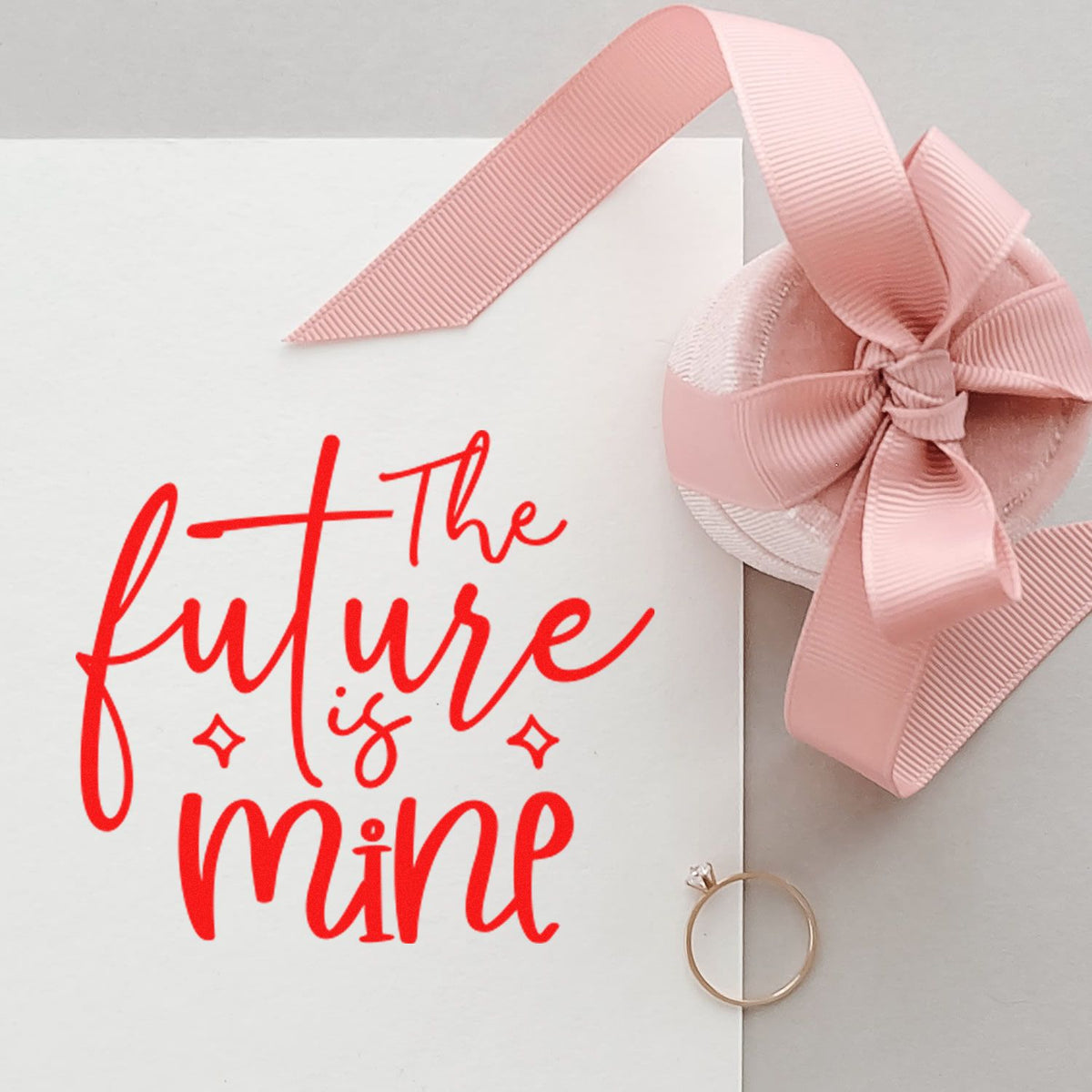 Custom rubber stamp design reading the future is mine with pink ribbon bow, ideal for wedding favors and gift packaging.