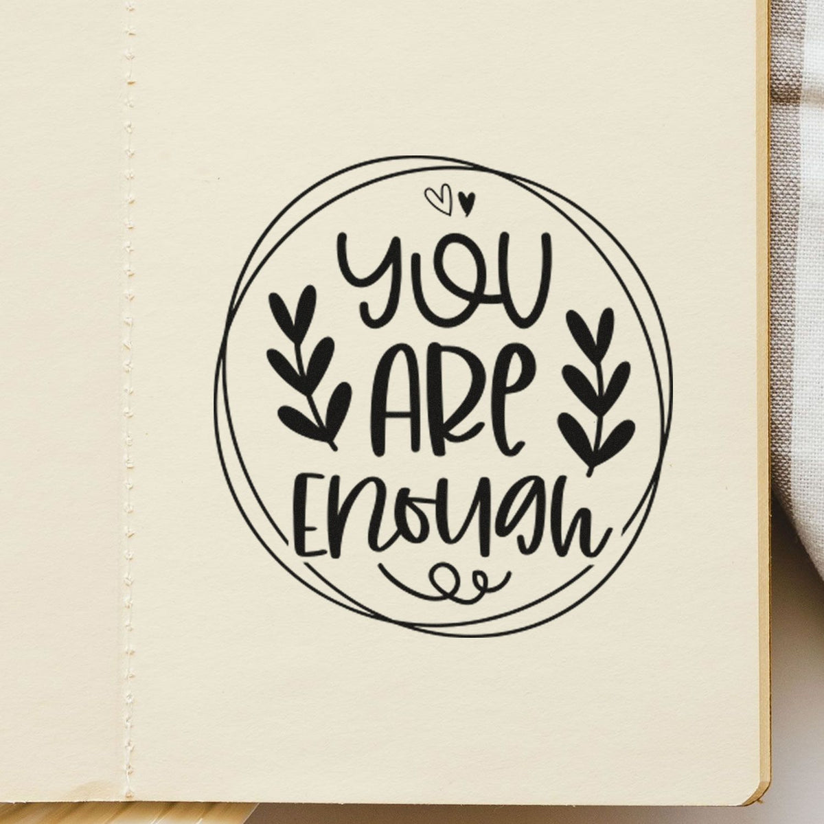 Handmade rubber stamp design reading "You Are Enough" with hearts and circle frame, ideal for journaling, cards, and crafts.