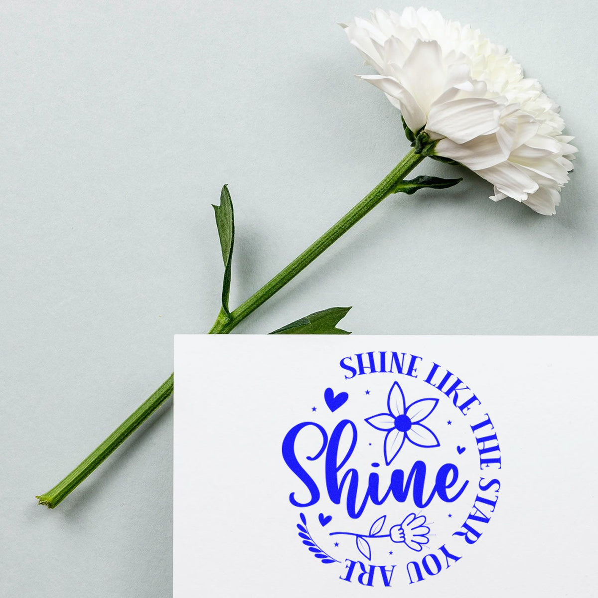 Inspirational floral rubber stamp with Shine Like the Stars You Are quote in bold blue ink.