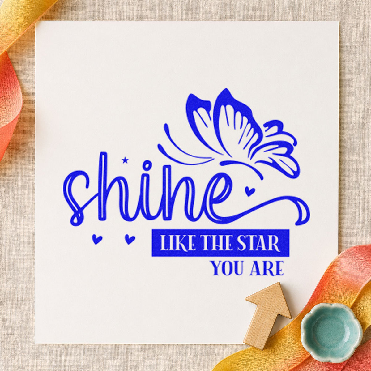 Shine Like Star Butterfly craft stamp imprinted in blue ink on paper, a design suited to framed rehearsal room.