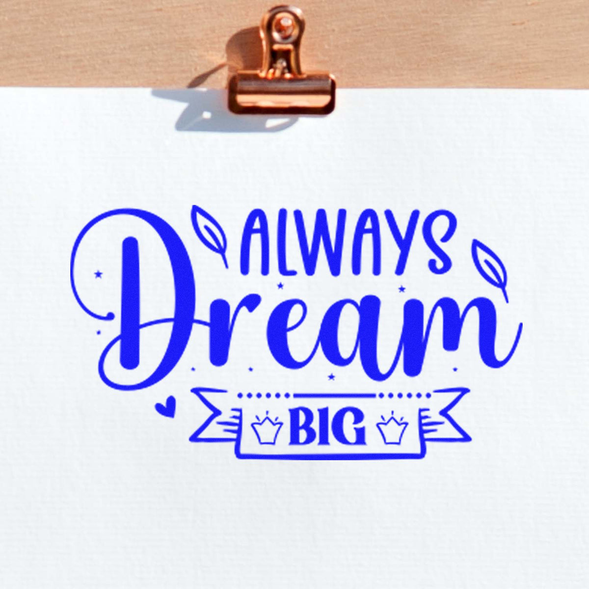 Blue custom rubber stamp impression reading Always Dream Big on paper, ideal for motivational stationery and crafts.