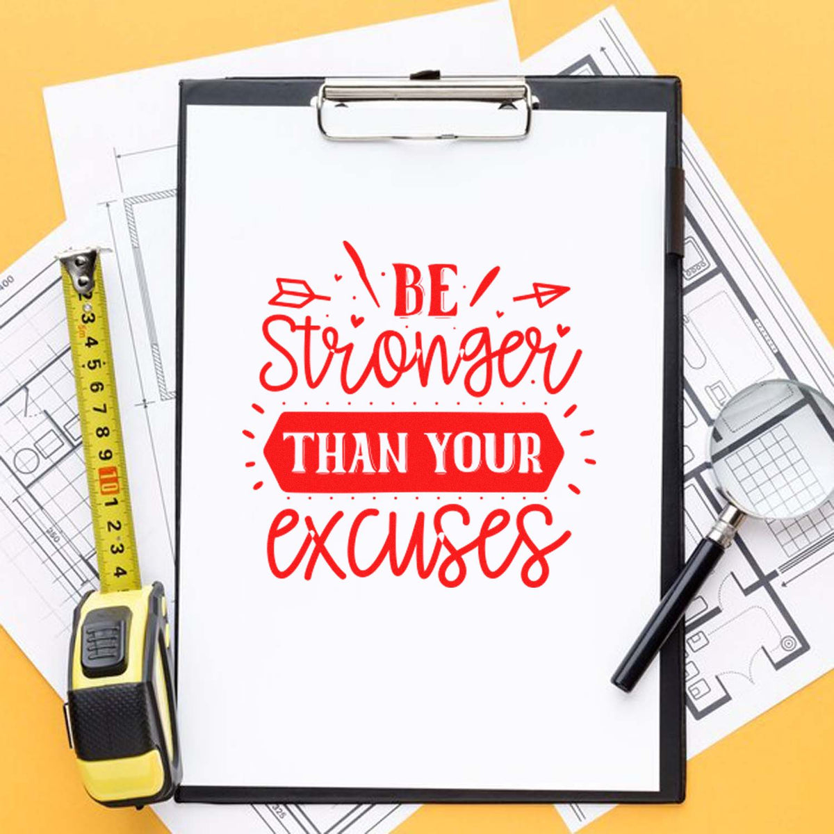 Custom rubber stamp mockup with Be stronger than your excuses motivational design on clipboard with drafting tools.