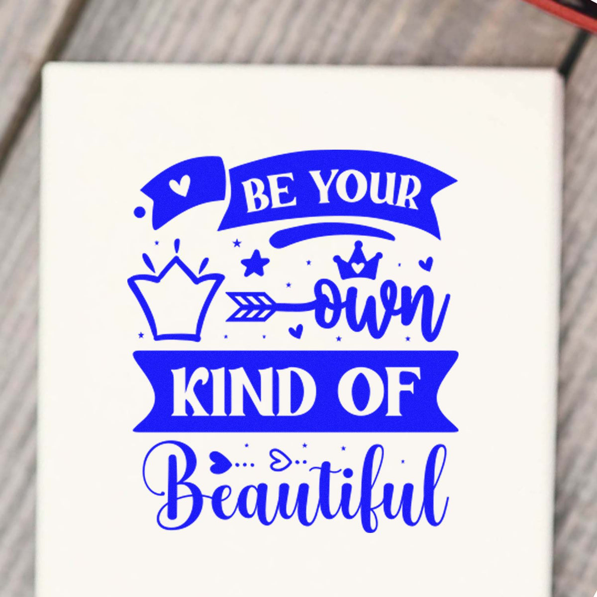 Custom rubber stamp design with Be Your Own Kind of Beautiful quote, crown, arrow and heart accents.